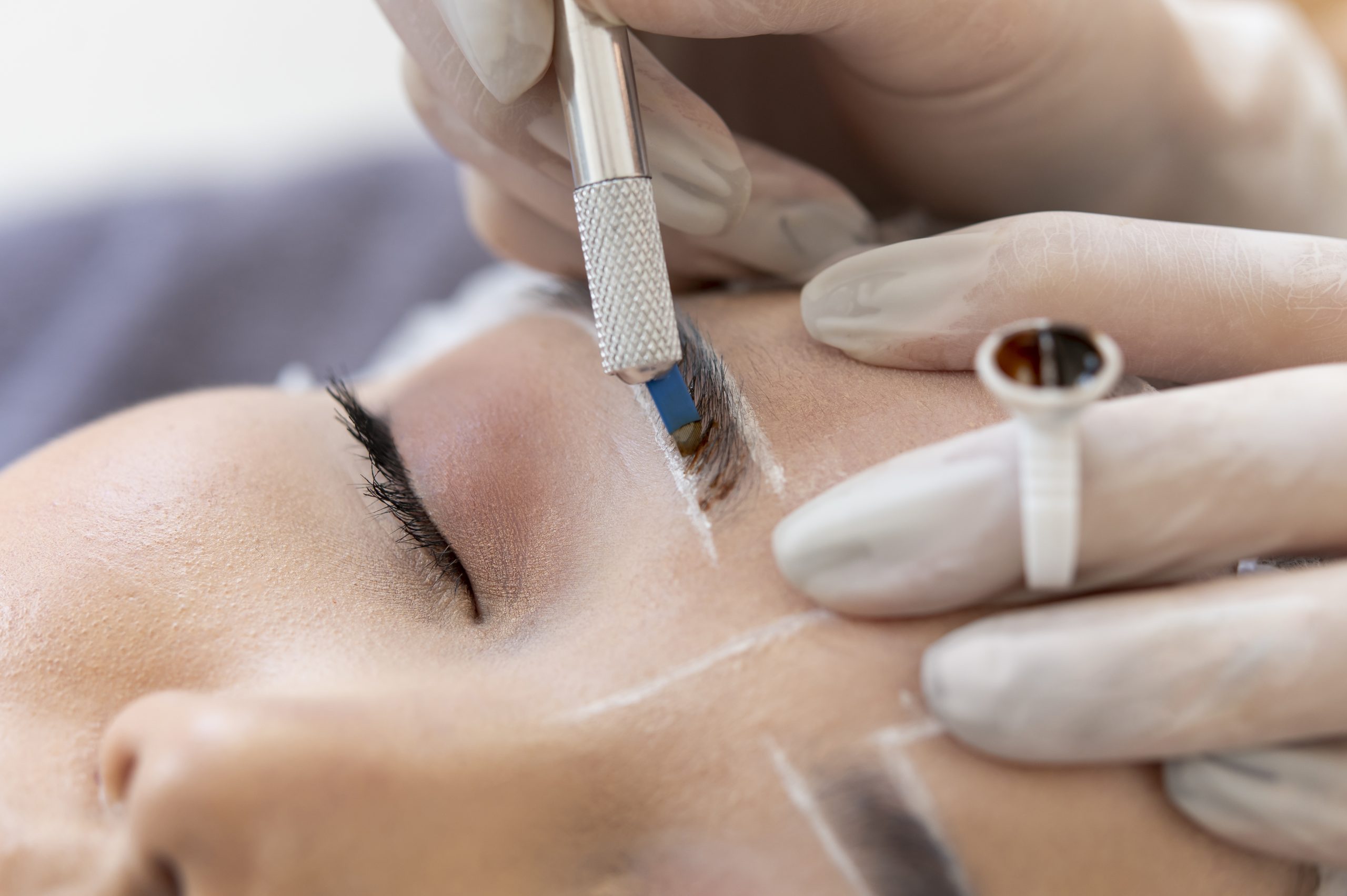beautician-doing-microblading-procedure-on-client-s-eyebrows